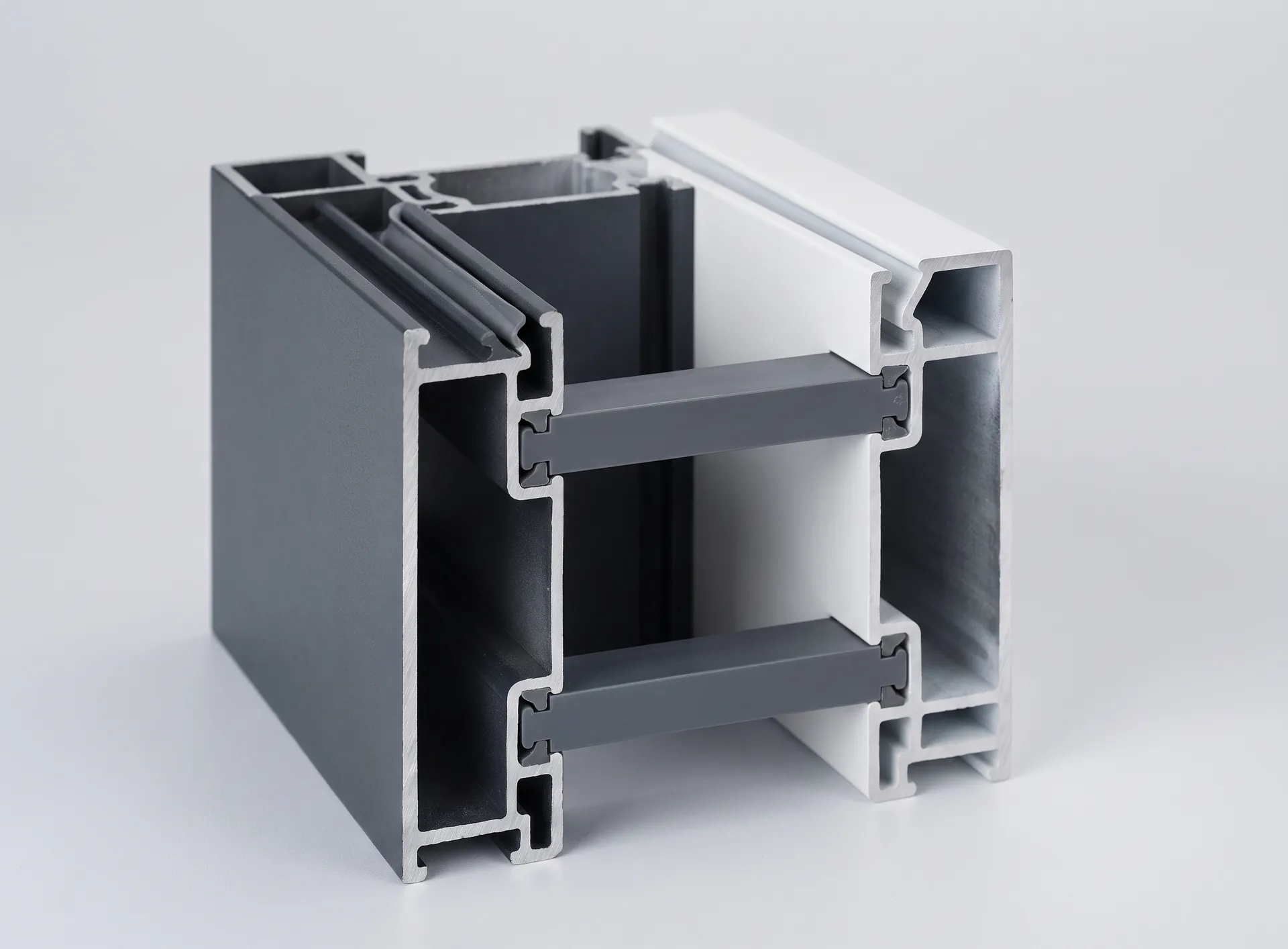 Cut section of an aluminium window profile showing the dark polyamide strips separating the outer and inner aluminium chambers