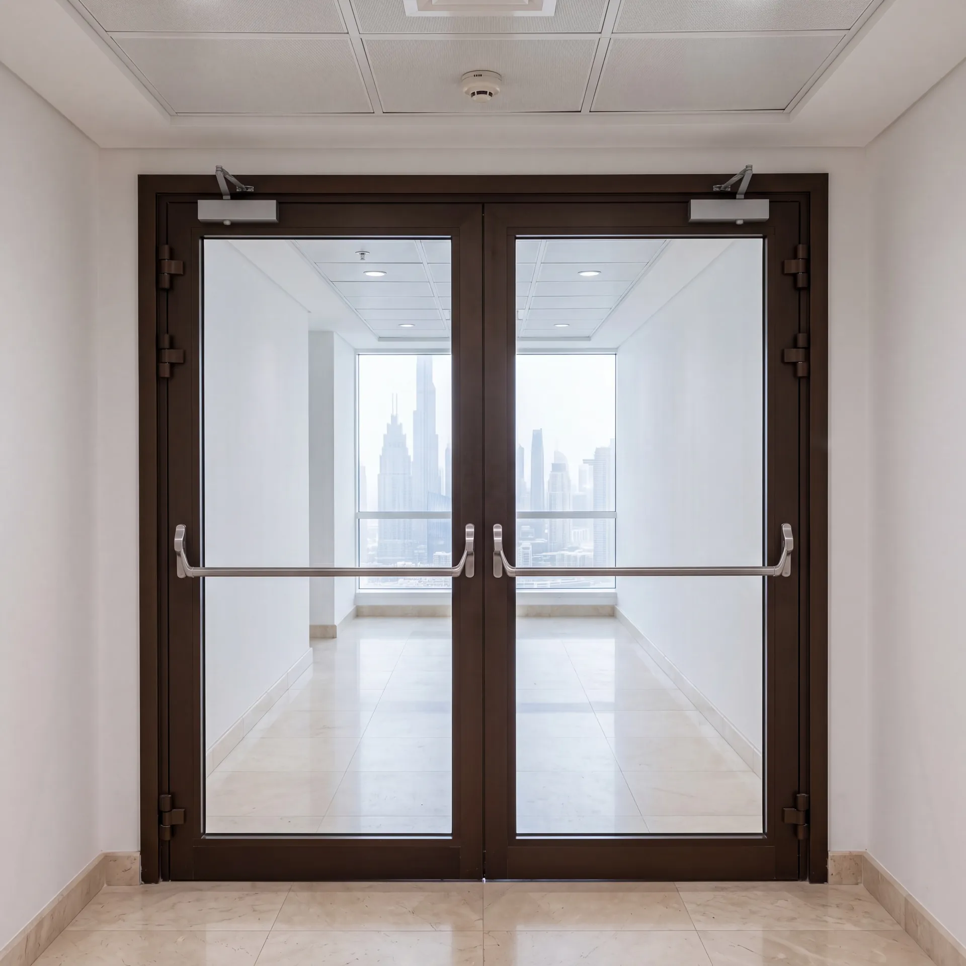 Aluminium fire-rated double door with push bar in a commercial corridor