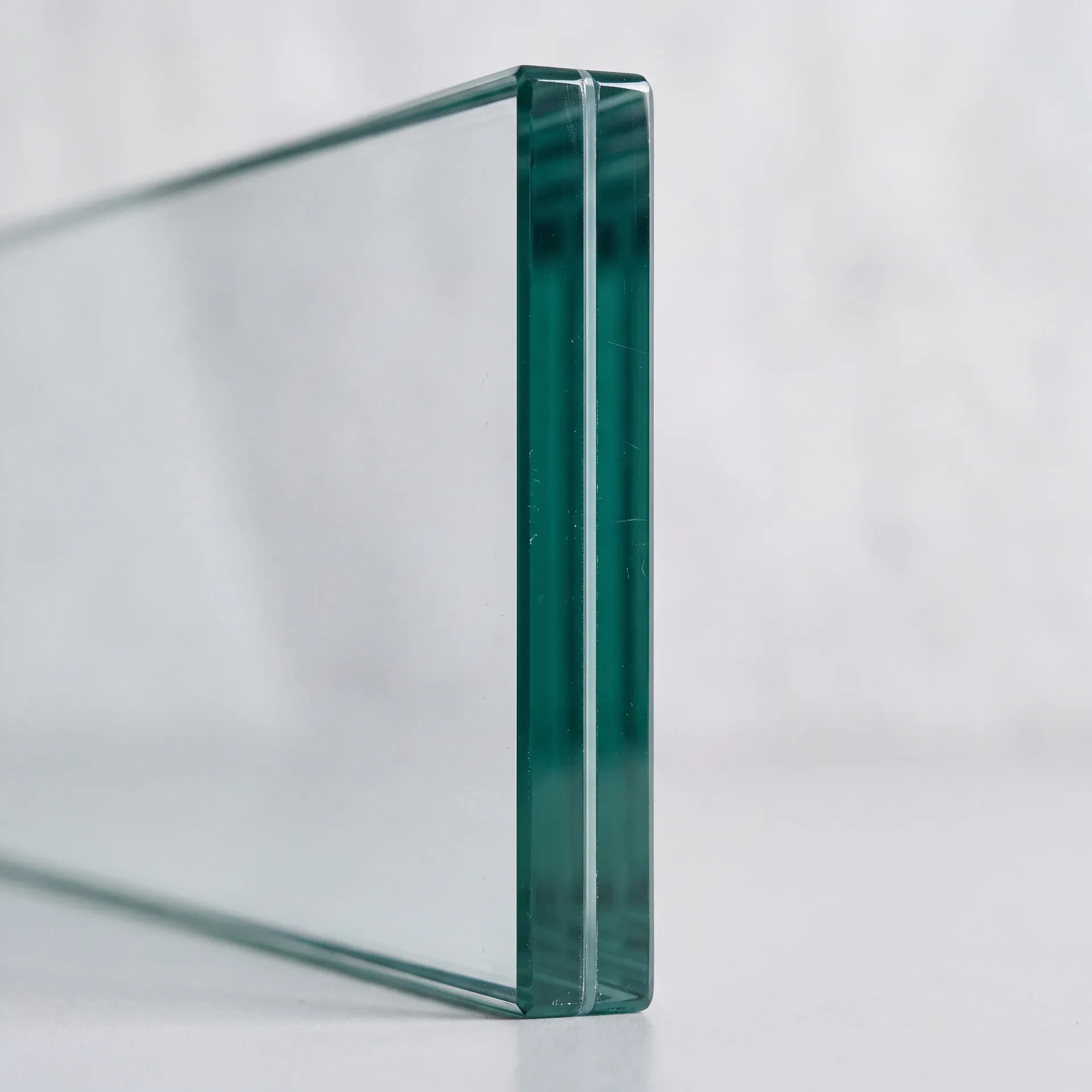 Polished edge of a laminated safety glass panel with the interlayer visible