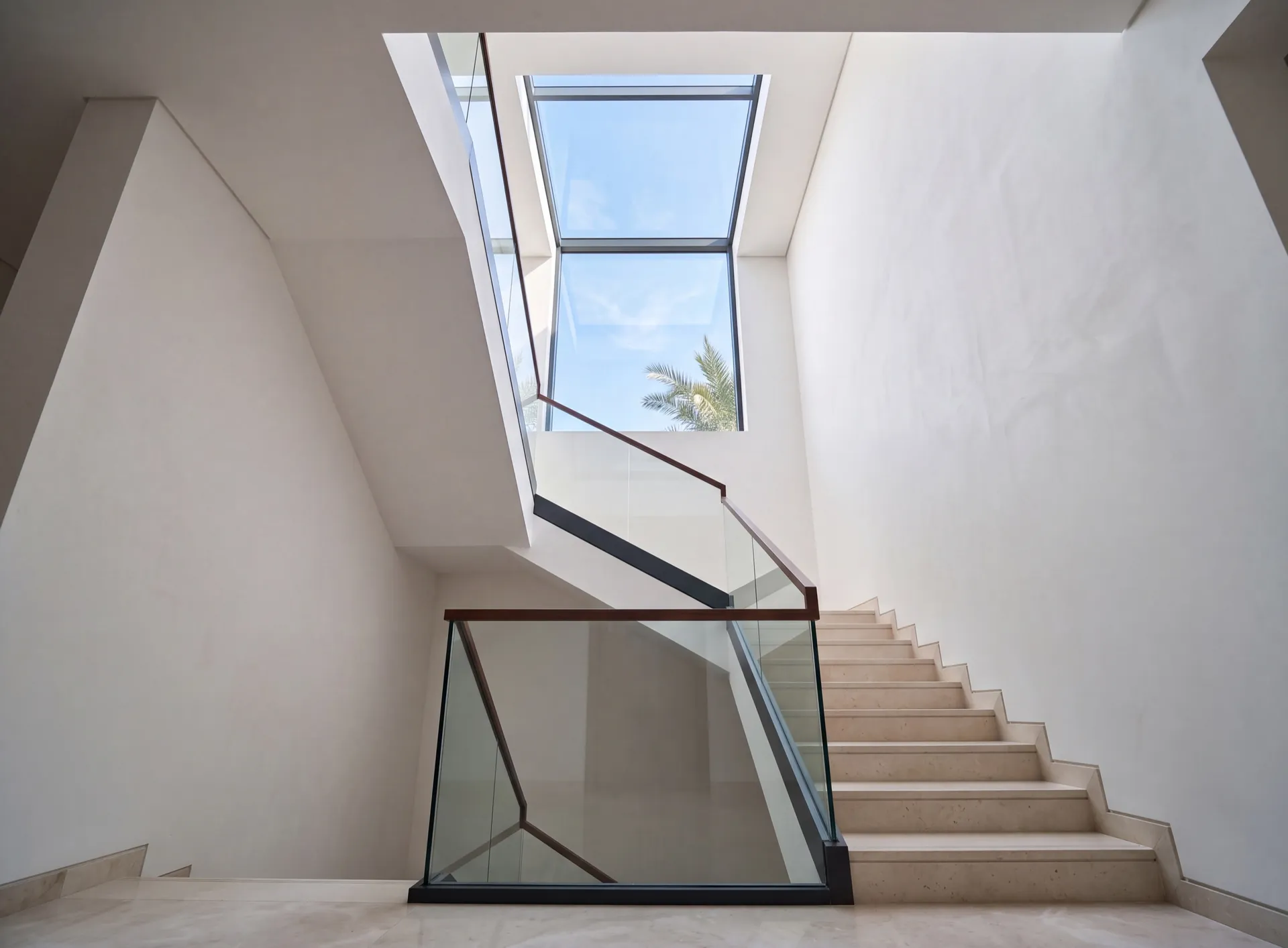 Aluminium skylight over a bright stairwell in a Dubai villa seen from below