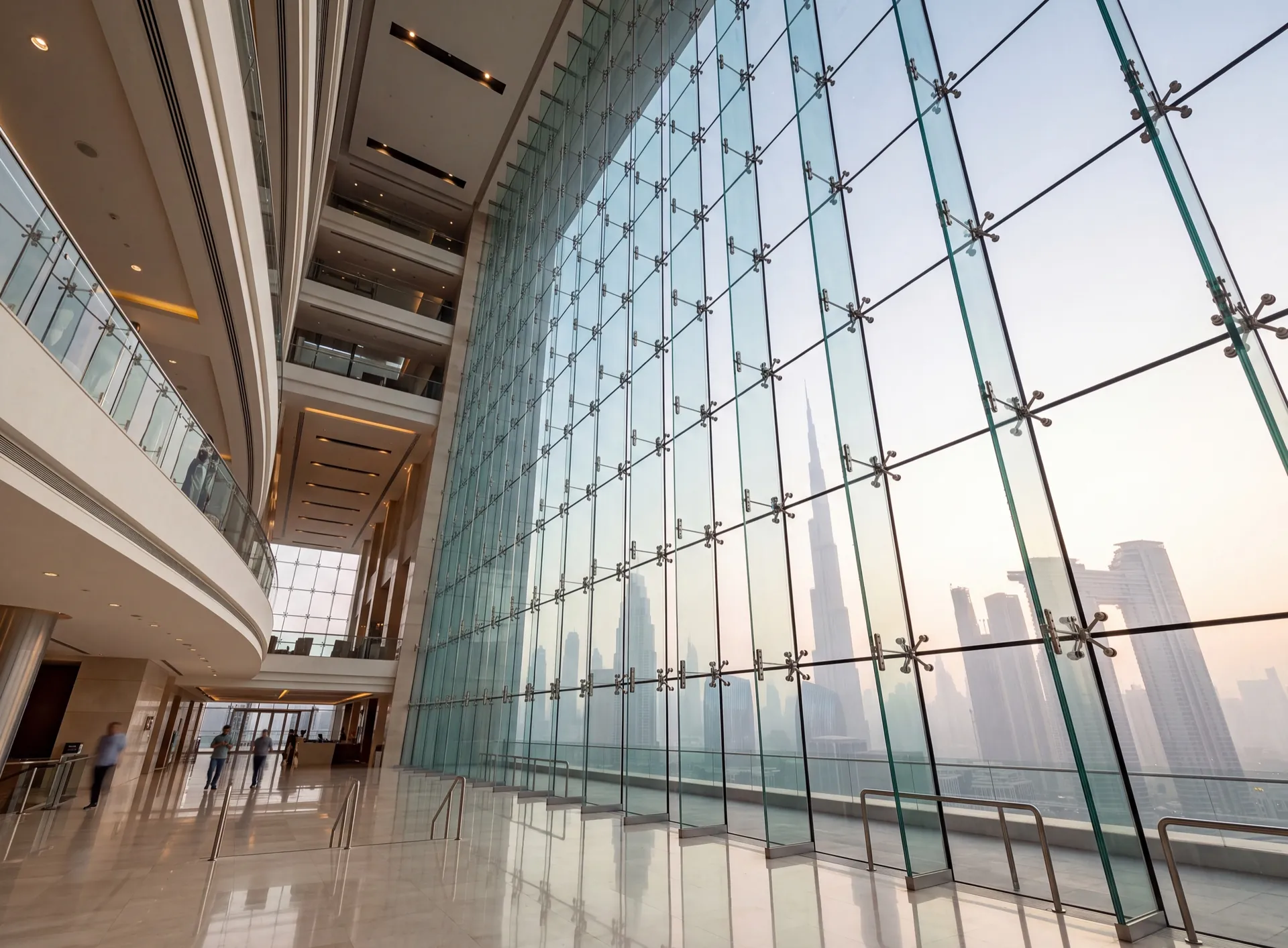 Bolted spider glazing wall in a Dubai hotel atrium with stainless corner fittings and glass fins behind