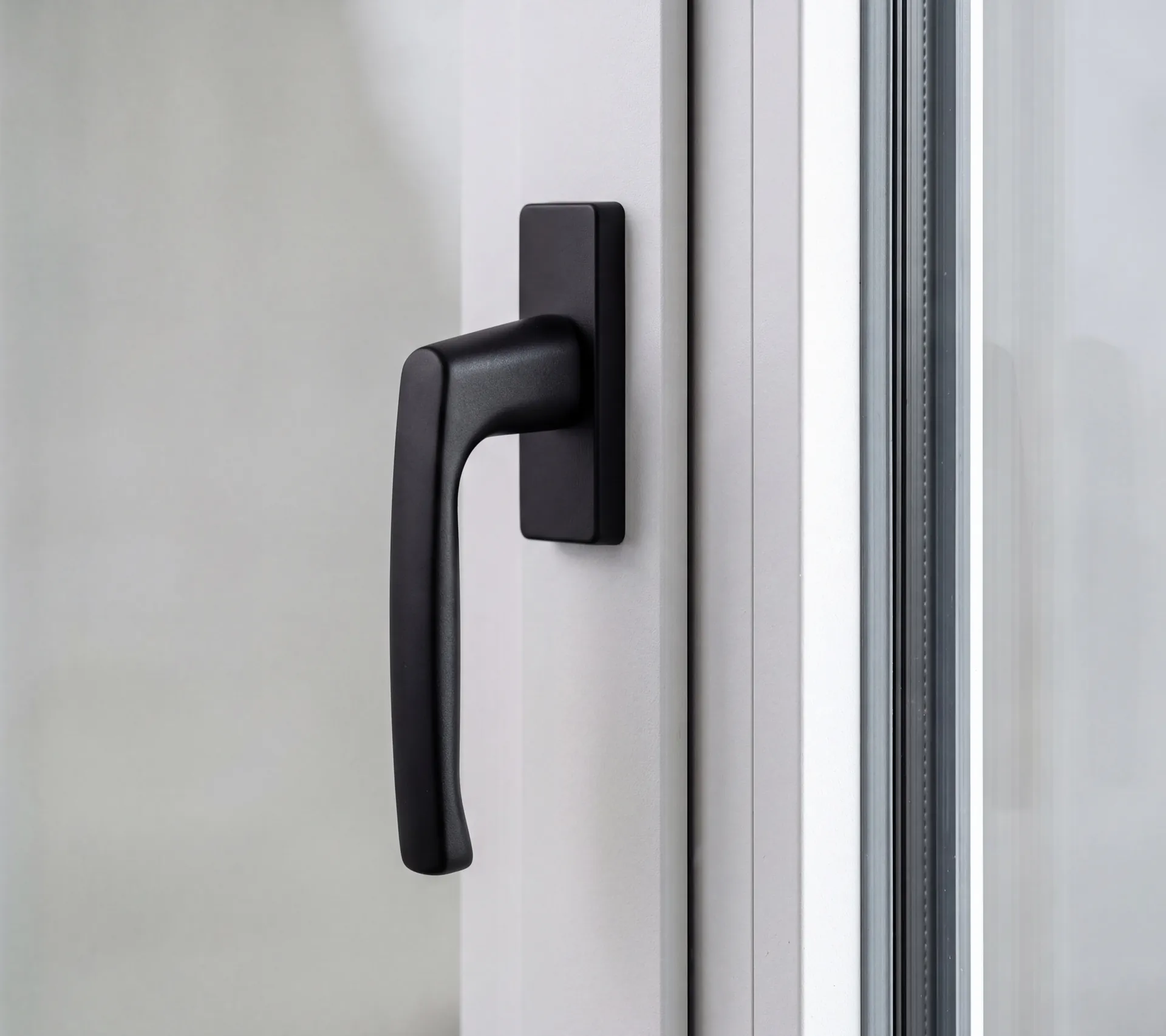 Black handle on a white aluminium window profile