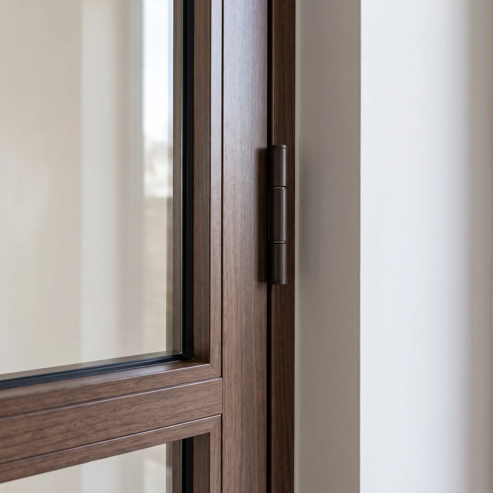 Dark wood-effect laminated aluminium door with hinge