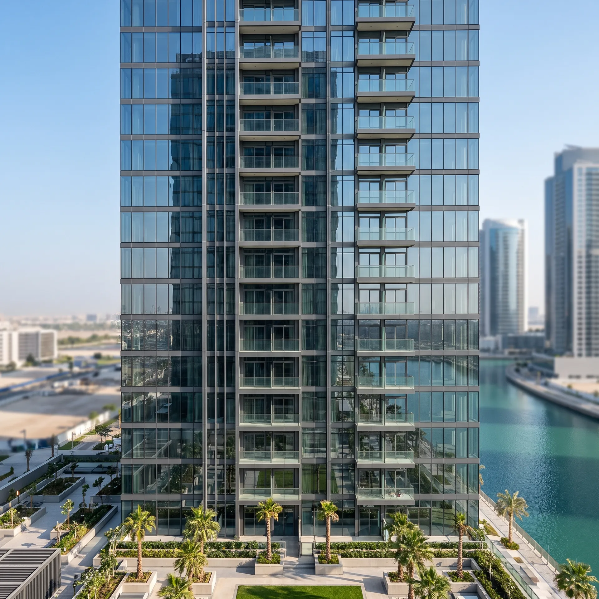 Glass-fronted residential tower on Al Reem Island with rows of glazed balconies, calm turquoise water and low buildings behind