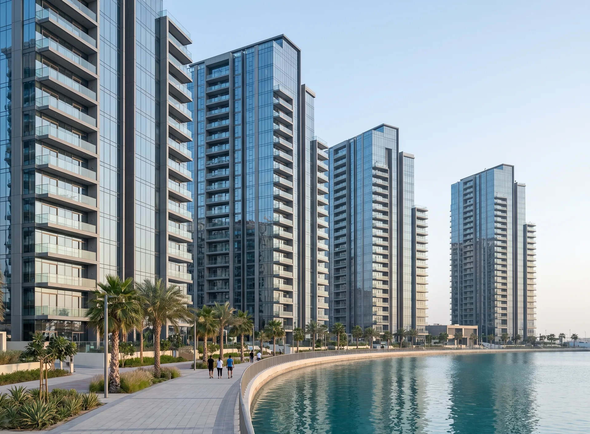 Cluster of glass residential towers on Al Reem Island seen from the waterfront, full-height aluminium glazing on the facades