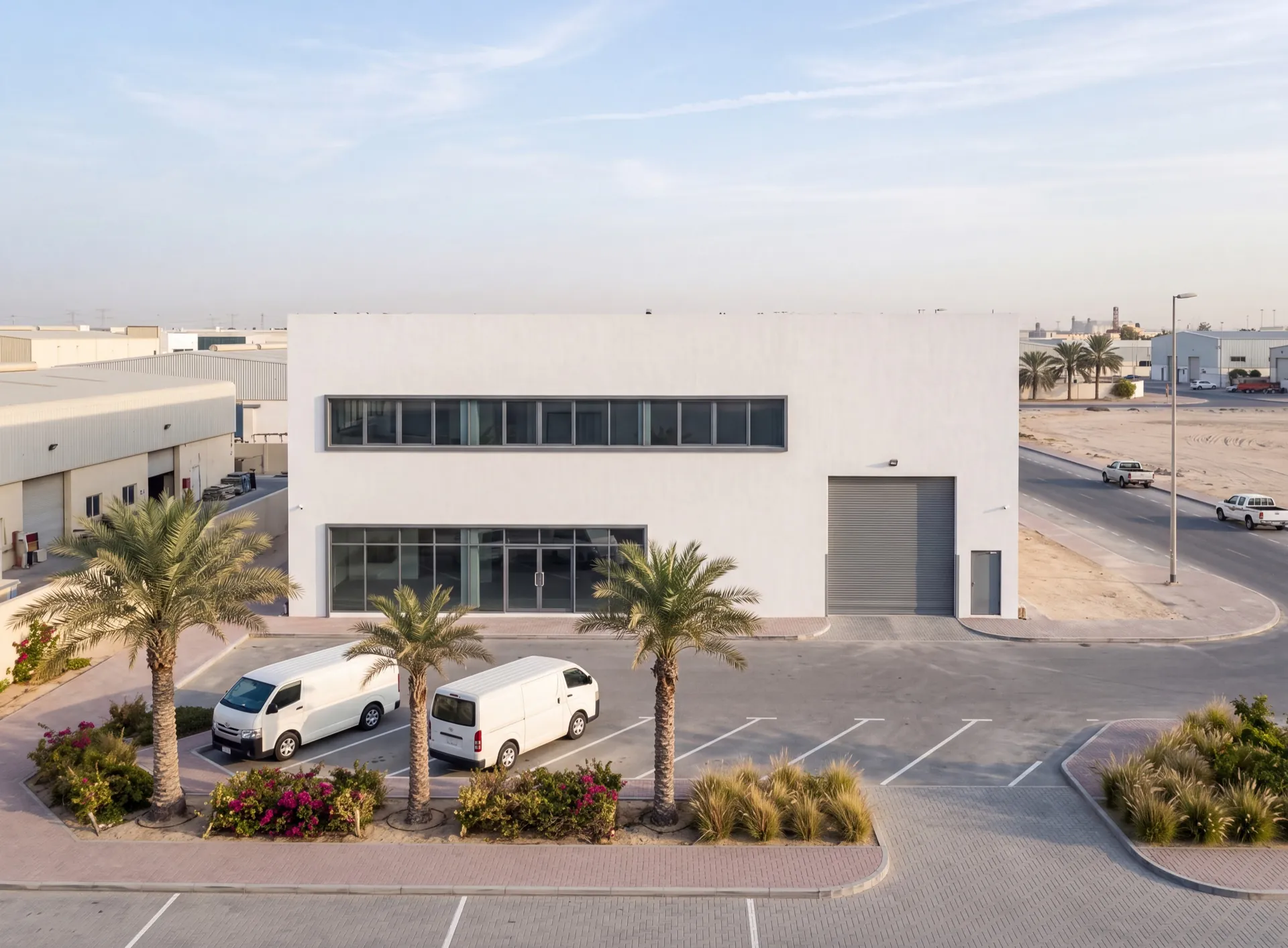 Plain white aluminium and glass premises of a window manufacturer in a Dubai industrial district