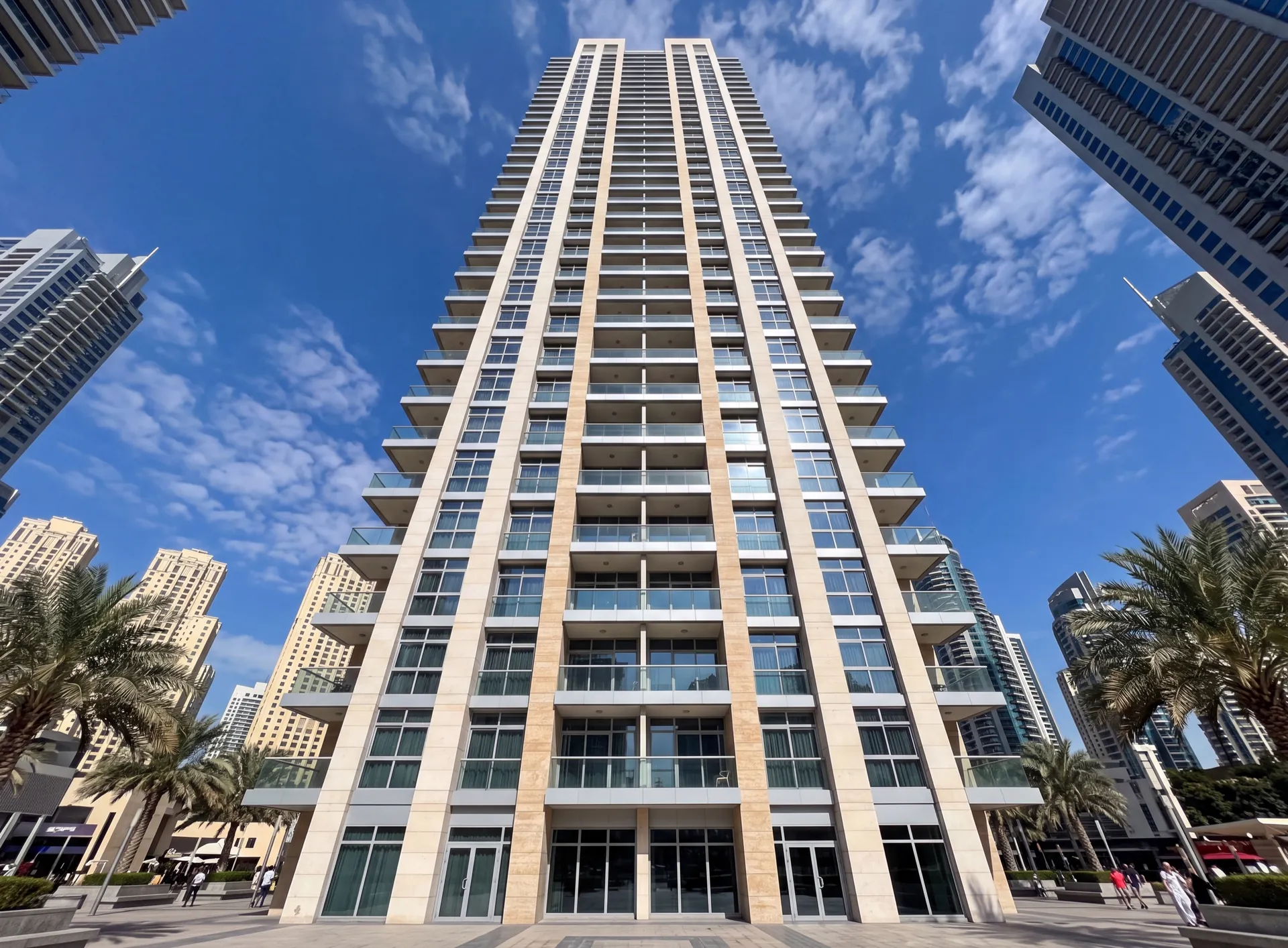 Facade of a residential high-rise tower in Dubai with repeating aluminium window openings seen from below